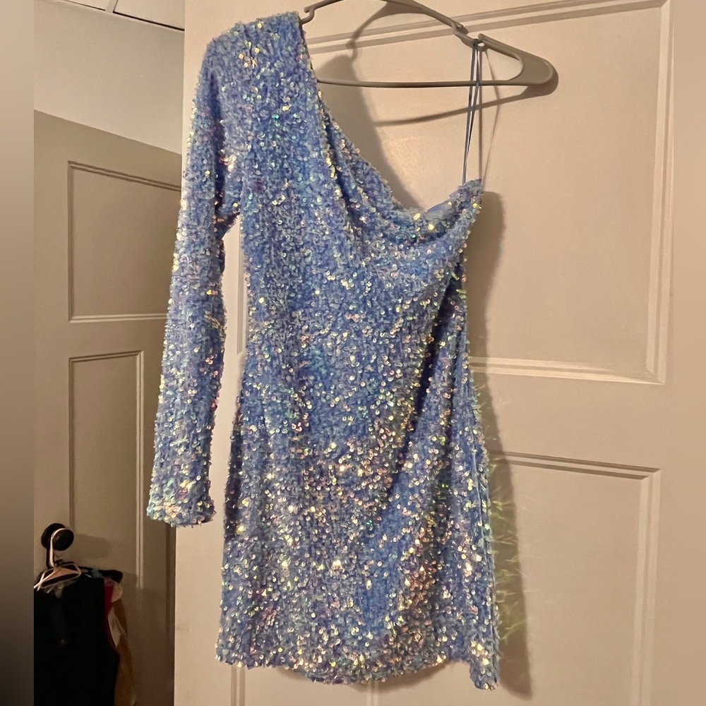 This dress is blue and full of sequins. Super cute one-shouldered, size small.